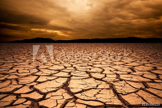 Picture of dramatic sunset over cracked earth Desert landscape background